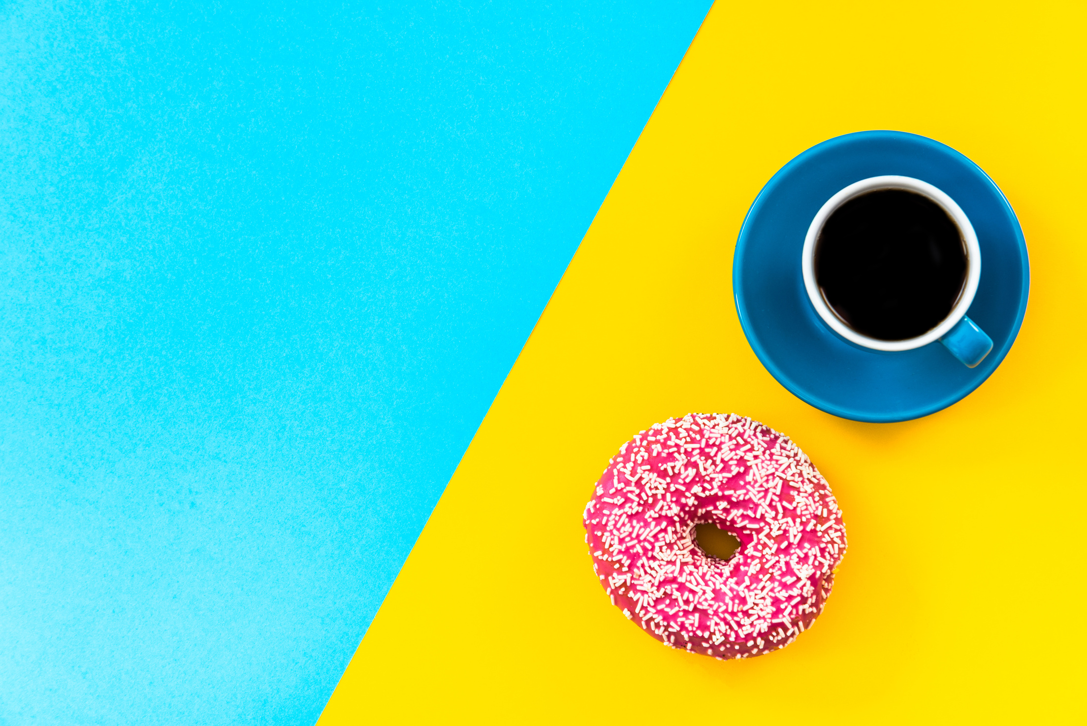 Coffee and donut on bright background